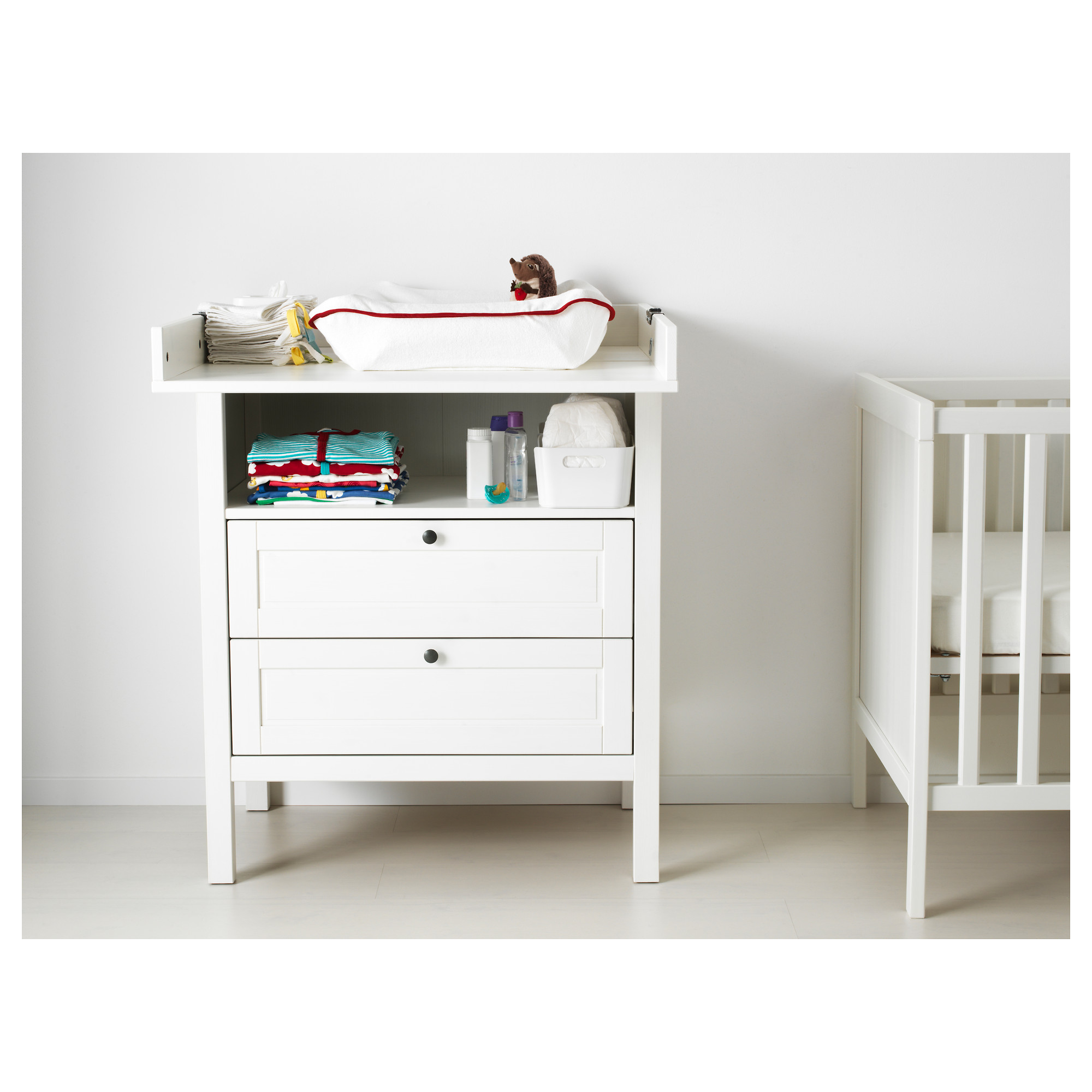 white chest of drawers with change table