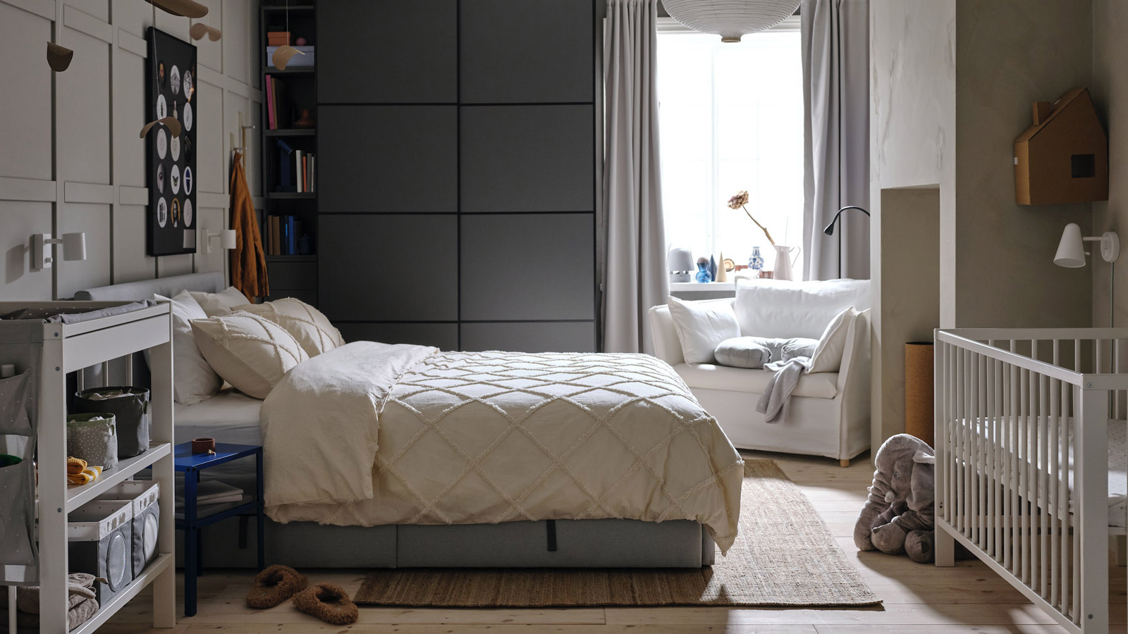 A grey shared parent baby bedroom in a modern style