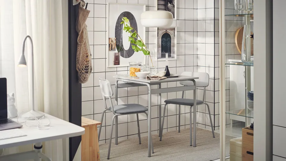 A dining room in a small modern studio apartment with a cool, urban vibe