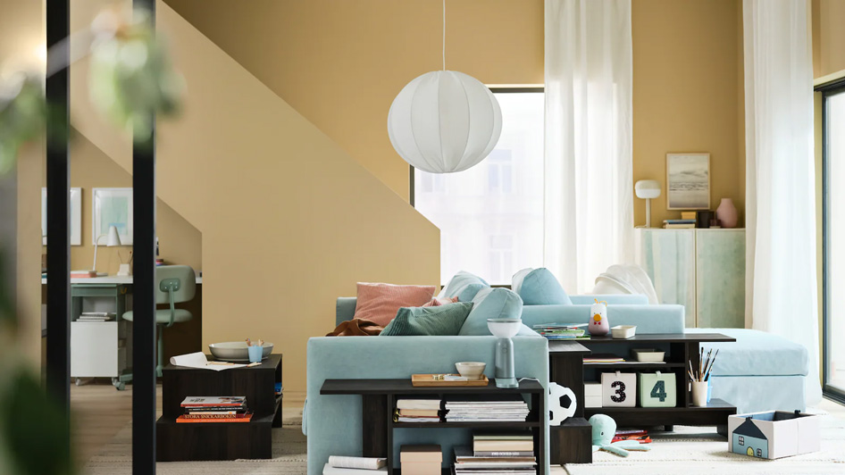 A modern living room with pastel colours and cosy corners